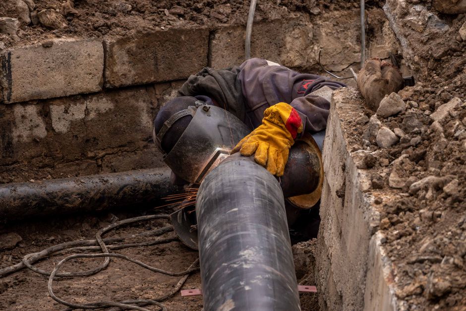 Close-up of a drain pipe being inspected for repairs in a Dorset garden
